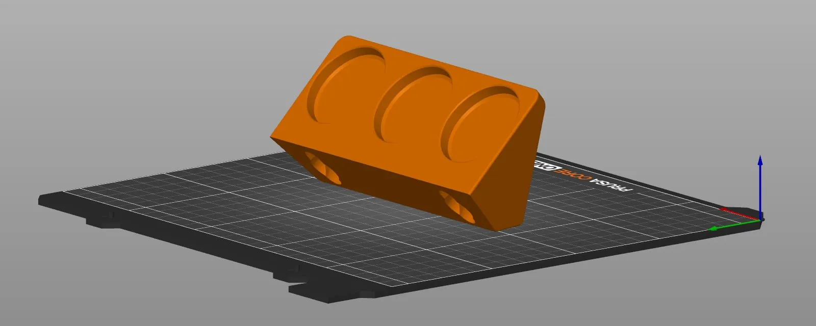 PrusaSlicer plate for the Prusa CORE One with the orange rack standing on the 45 degree bevel along the bottom of its back, the three countersinks facing up at an angle and the two keyhole slots facing down